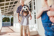 © Marko Geber - Grandfather and son bonding while playing with a soccer ball on house porch