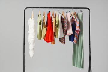 Canvas Print - Rack with stylish clothes on grey background