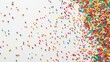 © Юлия Дубина - Colorful candy sprinkles scattered across a white surface