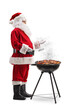 © Ljupco Smokovski - Full length profile shot of Santa claus grilling meat on bbq