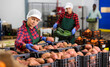 © JackF - Young woman farmer working at a vegetable depot inspects potatoes from crates