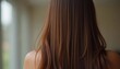 © Iuliia - Smooth, straight brown hair flows elegantly down back, highlighting its healthy shine and uniform color, illuminated by soft lighting, creating striking look. Hair care, the effect of cosmetics. AI