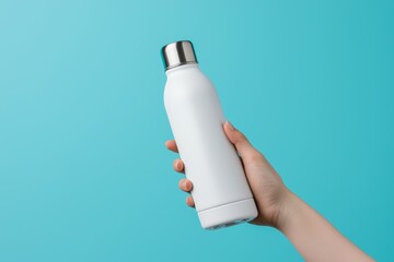 Wall Mural - A person is holding a white water bottle