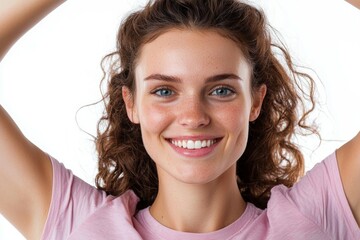 Canvas Print - A woman with curly hair is smiling and wearing a pink shirt