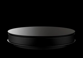 A simple black circular platform on a dark background, ideal for product displays.