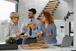 © Novak - Hungry business people eating pizza at break time in office