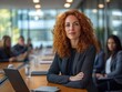© Phoenix AI Photo - Confident businesswoman with curly red hair at a modern conference table.