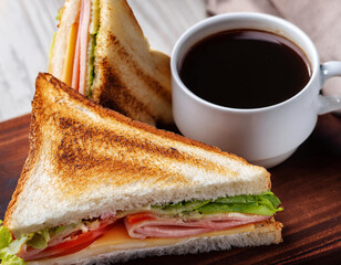 Breakfast menu with a club sandwich and coffee cup 