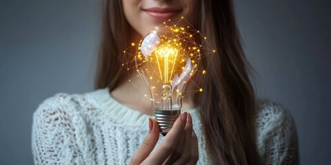 Fototapete - A woman holding a glowing light bulb symbolizing global internet connectivity and technological advancements in business, finance, and big data.