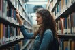 © Thanapong - A young woman in a library, searching through shelves filled with books, her hand reaching for a title, capturing the love of learning and discovery