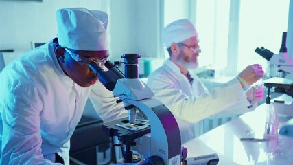 Wall Mural - chemists analyzing chemical compounds in advanced laboratory with neon lighting
