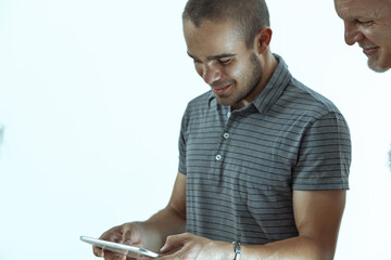 Two male colleagues collaborating on a digital tablet project