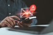 SMS spam, fake text message phishing from scammer concept. System hacked red warning alert, email hack, scam malware spreading virus on message alert virtual on mobile phone screen in person hand.