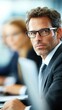 © HoursStudio - Focused Businessman Engaged in a Meeting with Colleagues in a Professional Setting