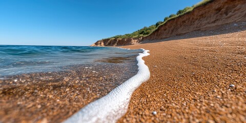 Sandy Beach Coastline with Clear Blue Water and Foamy Wave