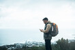 © Frank Coop/peopleimages.com - Hiking, phone and search with man on mountain for explore, travel and adventure. Challenge, wellness and location with person and mobile app in nature for backpacking, fitness and trekking vacation
