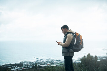 Hiking, phone and search with man on mountain for explore, travel and adventure. Challenge, wellness and location with person and mobile app in nature for backpacking, fitness and trekking vacation