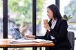 © David - Portrait of Asian business woman holding coffee cup with work in workplace office Business documents money financial planning concept