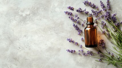 A brown glass bottle surrounded by fresh lavender flowers on a textured surface.