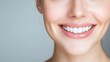 © Phirakhup - Close-up of a smiling woman showcasing bright teeth and a cheerful expression.