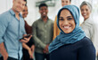 © peopleimages.com - Muslim woman, leader and team in office with portrait, smile and career with diversity at startup company. Person, manager and happy with hijab in group, excited or pride with job at creative agency