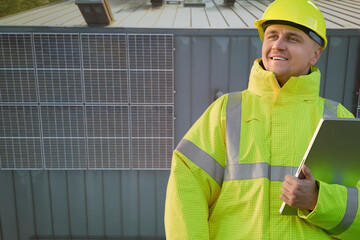 Solar panel installation worker with tablet