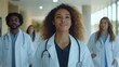 © Tahir AI - A diverse group of young medical professionals, walking confidently from a distance, shot from the front.