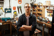 © peopleimages.com - Man, portrait or carpenter with confidence at workshop for woodwork, skill or talent in garage. Young, male person or professional artisan with arms crossed for timber, funiture or carpentry business