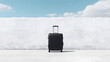 © Siwanart - Black Suitcase Against White Wall - Travel Essentials