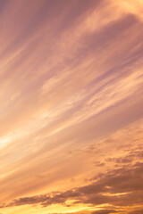 Wall Mural - Sky with soft and fluffy pastel orange pink and blue colored clouds. Sunset background. Nature. sunrise. Vertical