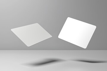 two blank business card mockups floating on a grey background with a soft shadow, two white round-cornered cards flying in the air for design presentation and branding mock-up template