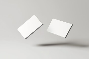 two blank business card mockups floating on a grey background with a soft shadow, two white round-cornered cards flying in the air for design presentation and branding mock-up template