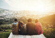 © Delmaine Donson/peopleimages.com - Friends, picnic and back of people in nature on mountain with view on holiday, vacation and adventure outdoors. Travel, group and men and women with blanket for bonding, relax and fun on weekend