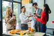 © NINENII - Asian business team are excited business success with inspiration from their excellent financial results, celebration successful deal with champagne and pizza in the workplace.