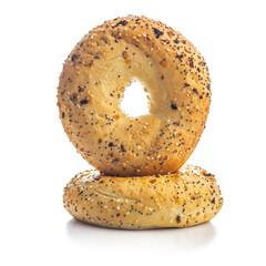 Canvas Print - Bagel sprinkled with fried onion, sesame and poppy seeds isolated on white background.