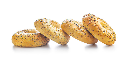 Canvas Print - Bagel sprinkled with fried onion, sesame and poppy seeds isolated on white background.