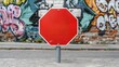 © wpw - Vibrant red stop sign contrasts with colorful graffiti wall, showcasing urban art and traffic safety in a lively setting.