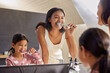 © Rido - Indian mother and little daughter brushing teeth in the morning