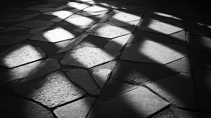 Monochrome geometric shadow pattern on pavement offering an abstract copy space image