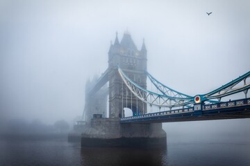 Wall Mural - Moody view of the Tower Bridge of London, England, during a foggy autumn day