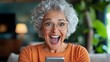 © tuiphotoengineer - Overjoyed Senior Woman Excitedly Reacts to Online Achievement Holding Smartphone and Expressing Elation in Chic and Modern Living Space Interior