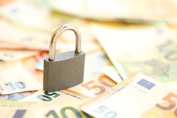 Wall Mural - Euro banknotes with lock on wooden table background