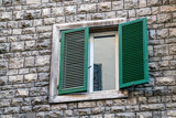 Italian style windows with green wooden shutters