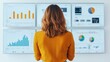 © nattapon98 - A woman with curly hair observes multiple data analysis screens showcasing various graphs and charts.