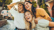 © Davide Angelini - Three multiethnic girls having fun walking in city street - Happy young women laughing together enjoying summertime vacation