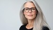 © MetaPixel - Portrait of an elegant mature Caucasian woman with long straight grey hair and glasses set against a clean white background in a square format