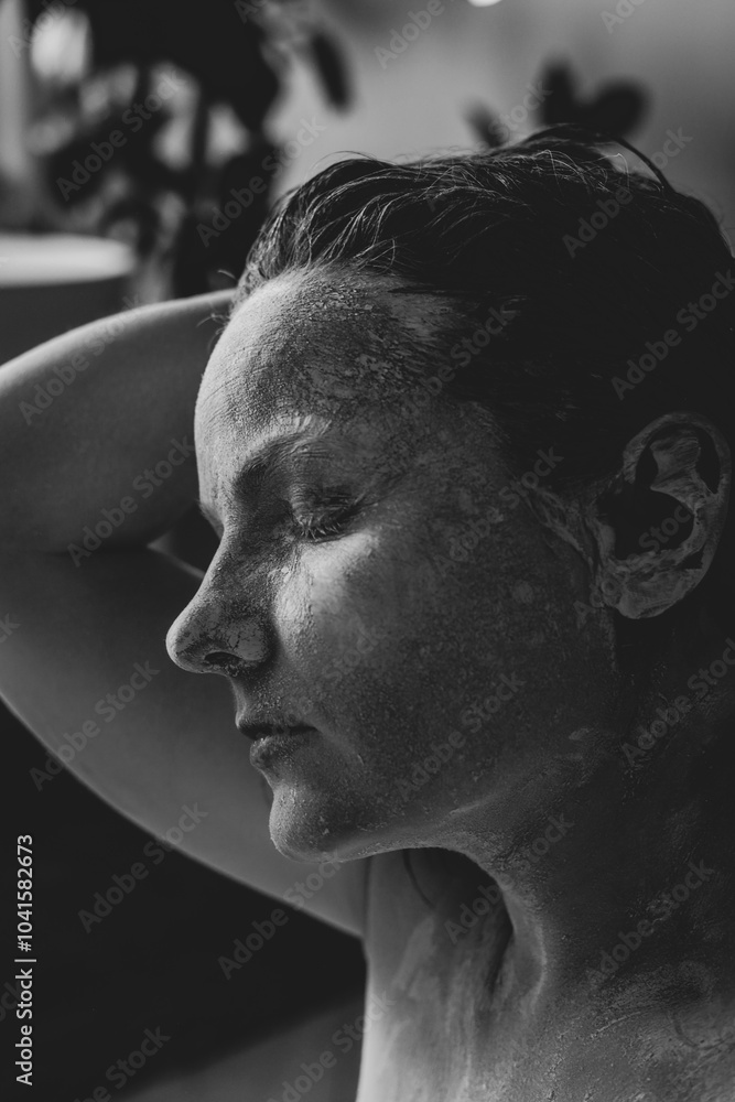 Beautiful naked female body on black background. Young sensual woman in