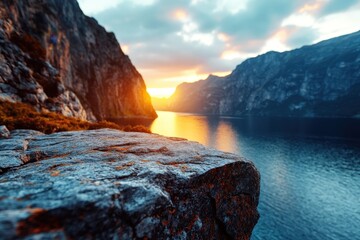 A tranquil fjord with rocky cliffs at sunset, highlighting a serene and peaceful landscape, showcasing the natural beauty of a sunset over water and mountains.