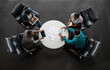 © JonoErasmus - Diverse African Business Team Collaborating Around Modern Meeting Table