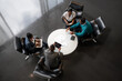 © JonoErasmus - Top View of Diverse African Team in Collaborative Meeting